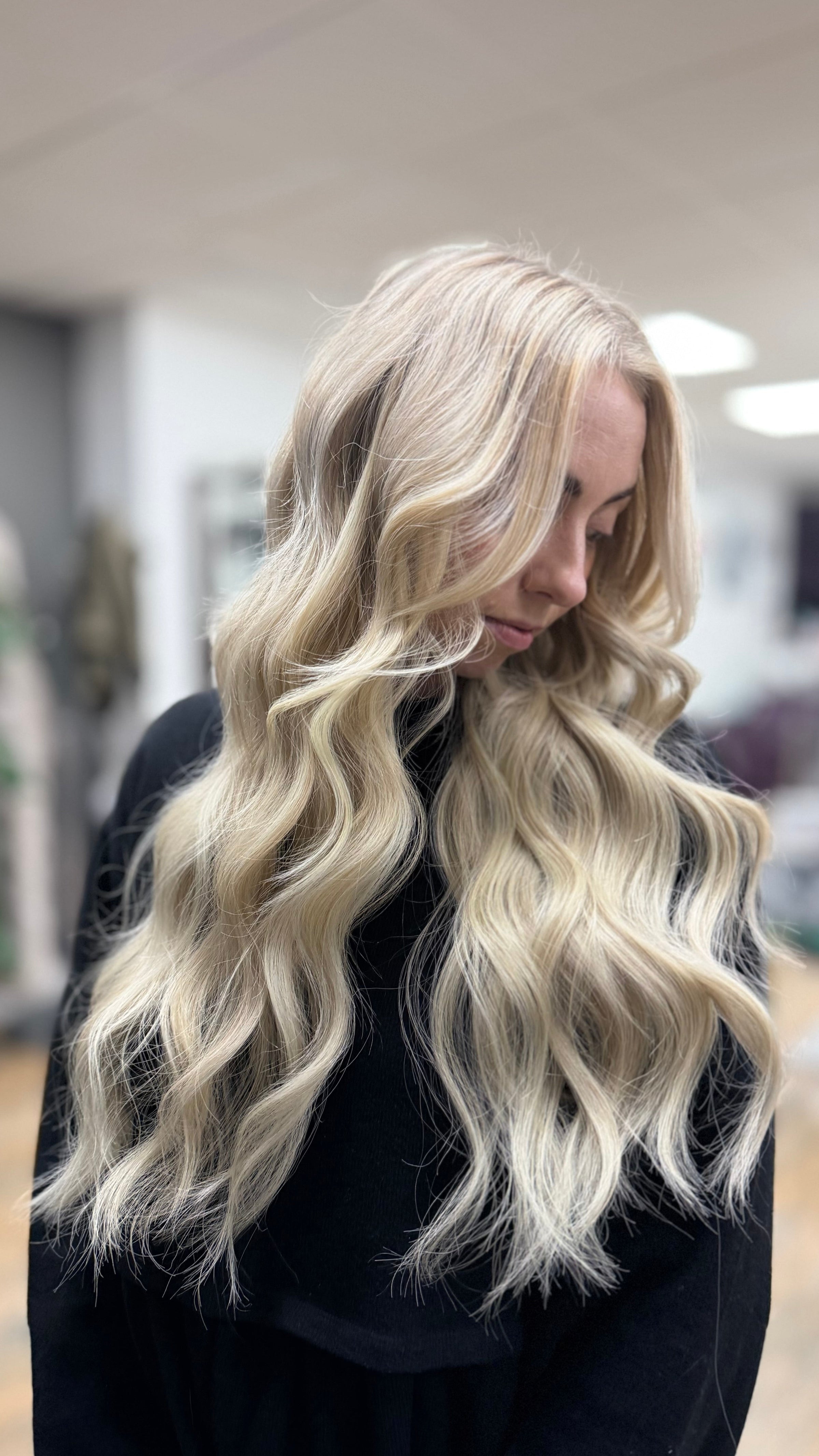 Woman with long, wavy blonde hair extensions in Bridgend